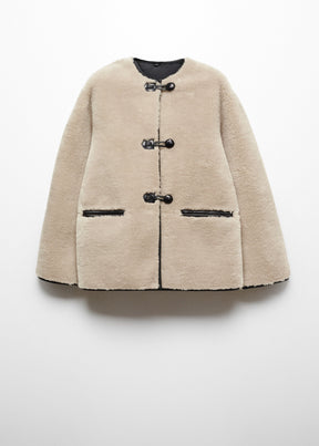 Faux fur coat with applications