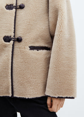 Faux fur coat with applications